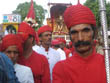 jaipur tourism | goddess teej in silver palanquin and porters in red dress with special turban and silver pole in hand