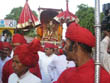 jaipur tourism | goddess teej in silver palanquin along with porters, attendants and their chief.  Three different styles of turbans as per designation can see in this photo