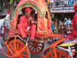 jaipur tourism | a folk artist playing shehnai while he is sitting in a palanquin